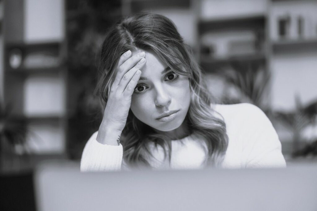 frustrated young woman in front of a computer